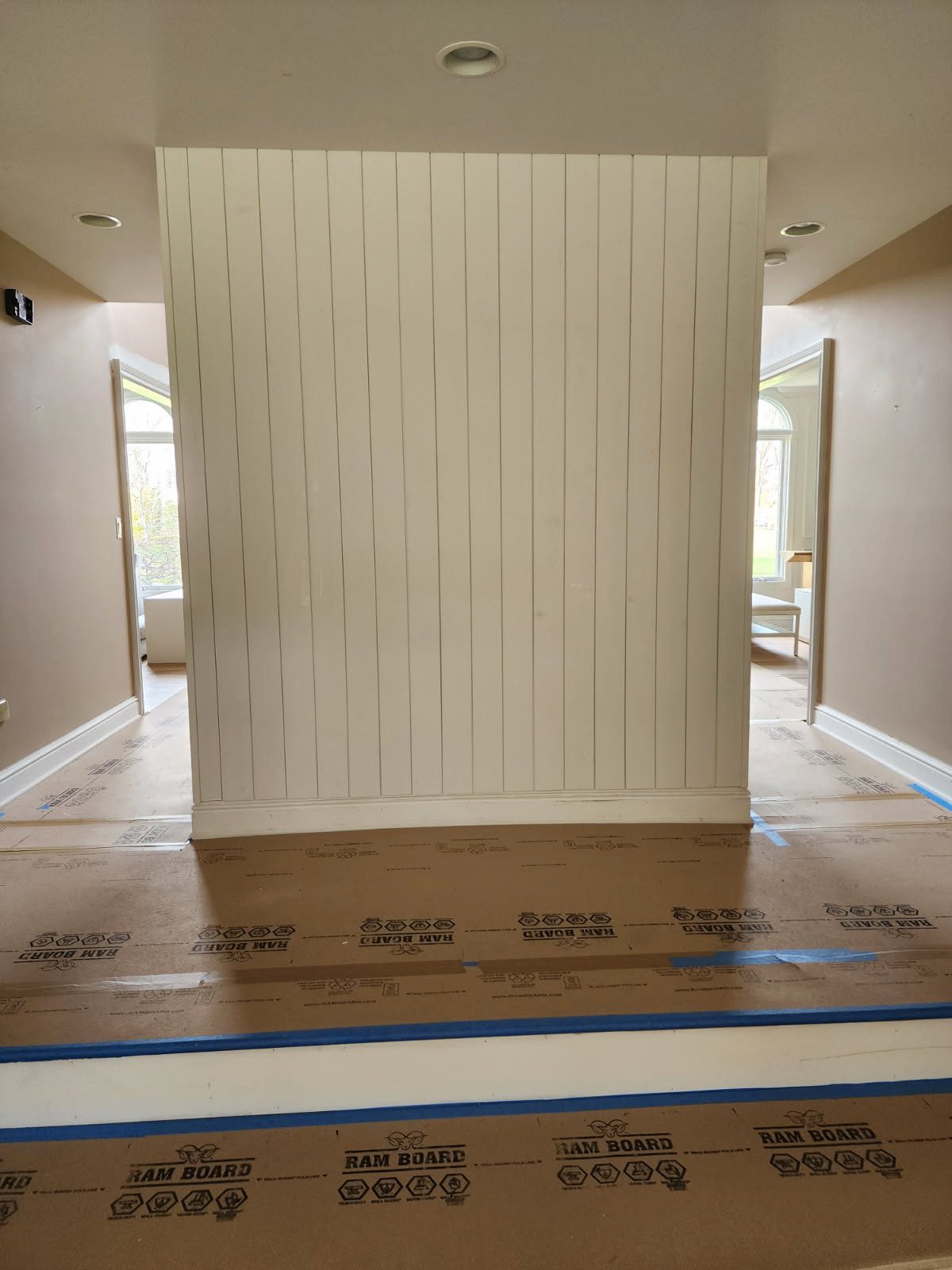 Detailed white panel molding with arch window